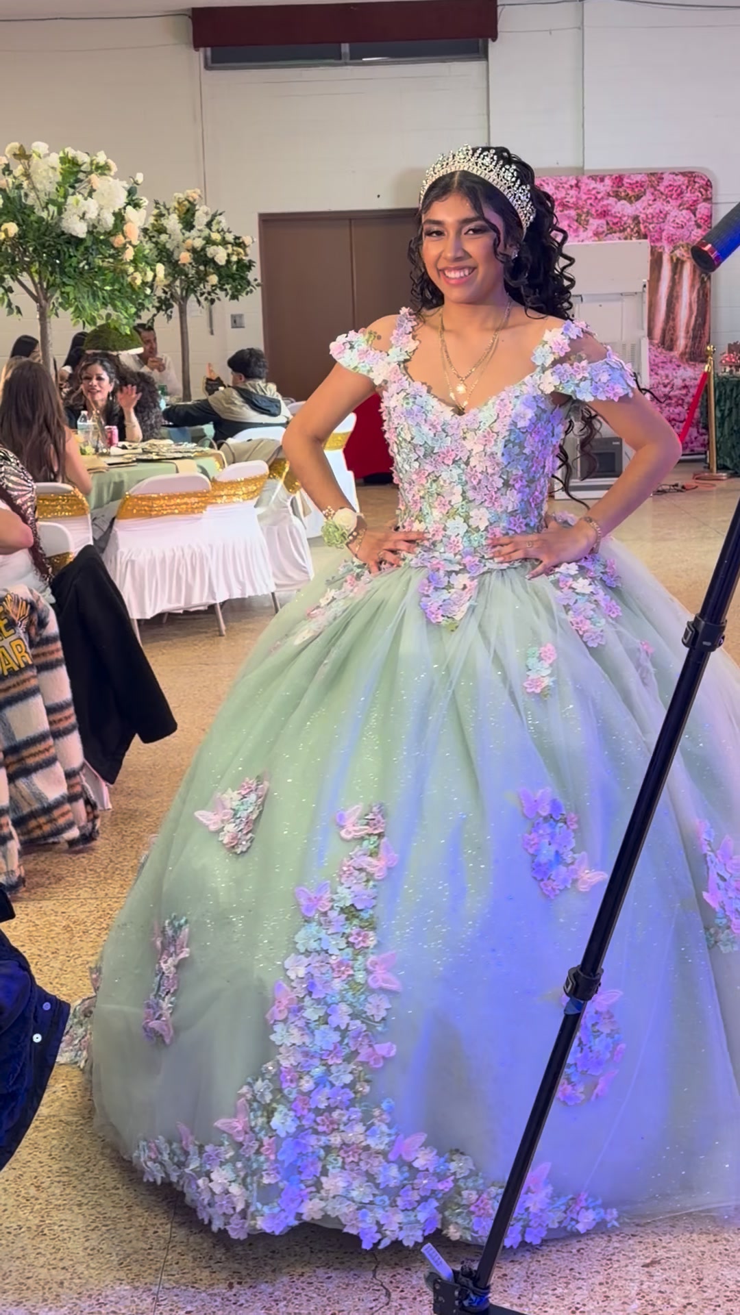 Model in turquoise quinceañera ball gown.