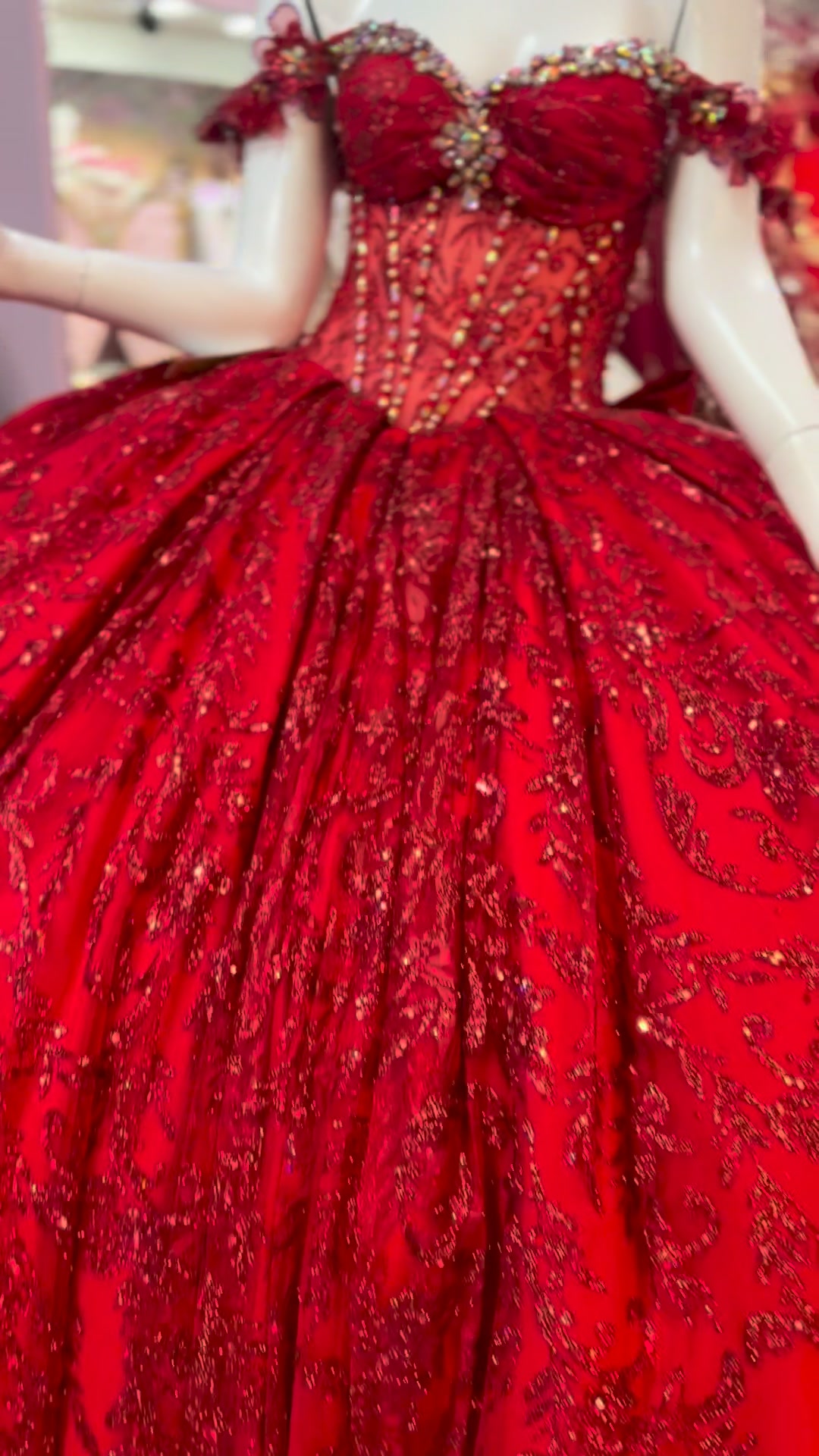 Red quinceañera gown detail with sparkling bodice and full skirt.