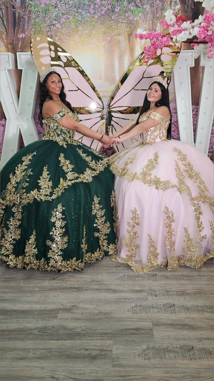 Two quinceañera dresses displayed in a boutique setting.